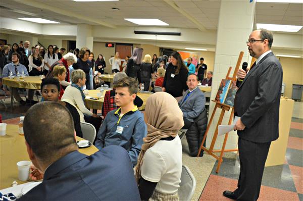 Dr. Sherlock welcomes guests to the breakfast 